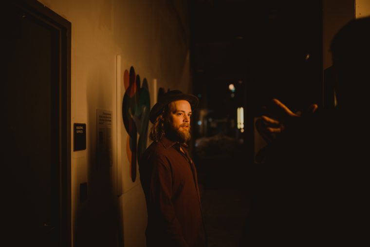 Mark Lavengood in a dim hallway looking back at camera